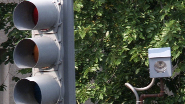 A camera is placed near a traffic light for drivers who run red lights on Constitution Avenue Aug. 31, 2001, in Washington, D.C. 