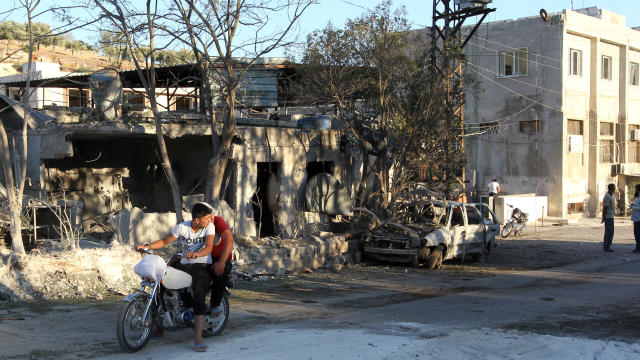 ​People inspect the damage as they stand near a Save the Children-sponsored maternity hospital after an airstrike in the rebel-controlled town of Kafr Takhareem in Idlib province, Syria, July 29, 2016. 