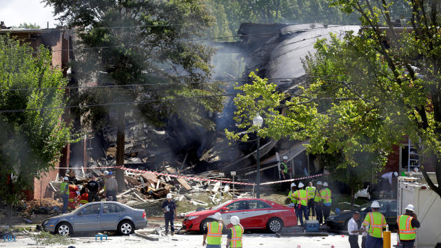 ​Firefighters look through the debris of a four-story building that was destroyed in a deadly explosion in Silver Spring, Maryland, Aug. 11, 2016. 