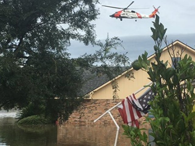 Coast Guard chopper flies over flooding in Baton Rouge, Louisiana on August 14, 2106