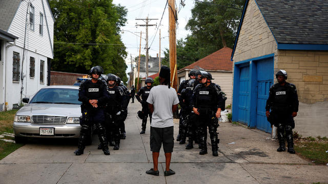 Police in riot gear assemble in an alley after disturbances following the police shooting of a man in Milwaukee, Wisconsin, Aug. 15, 2016. 