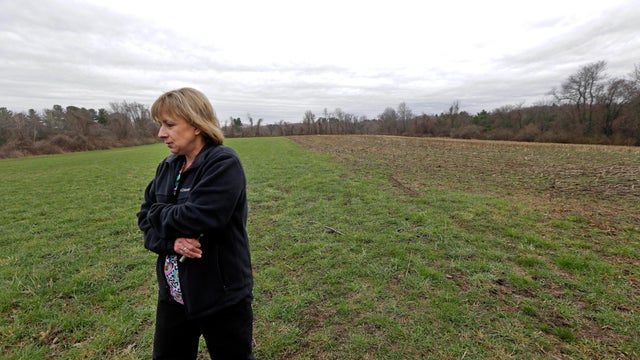 Desiree Moninski walks on land located across from her house in Dudley, Mass., which is the site of a proposed Muslim cemetery, a project vigorously opposed by area residents, April 12, 2016. 
