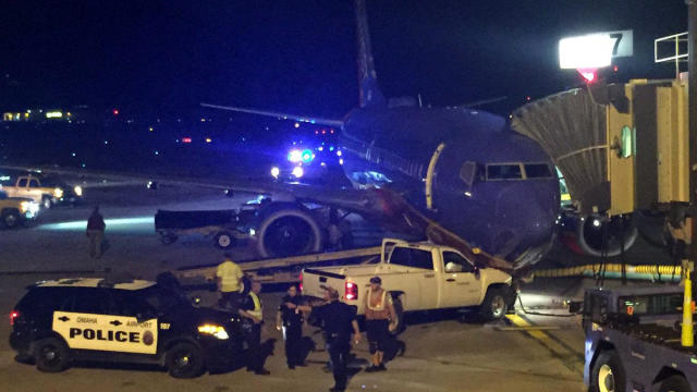 Crews work the scene after a motorist breached a perimeter fence at Eppley Airfield in Omaha, Nebraska, and drove an airline pickup truck into a Denver-bound Southwest Airlines plane on Aug. 25, 2016. 