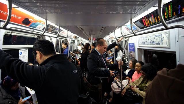 Morning commuters ride the subway in New York on May 11, 2016. 