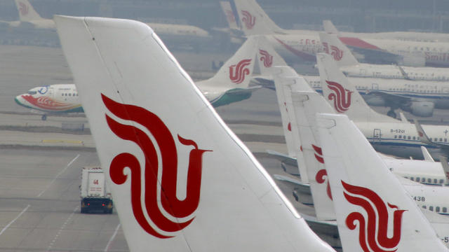 Air China planes are parked on the tarmac of Beijing Capital International Airport in Beijing, China, March 28, 2016. 