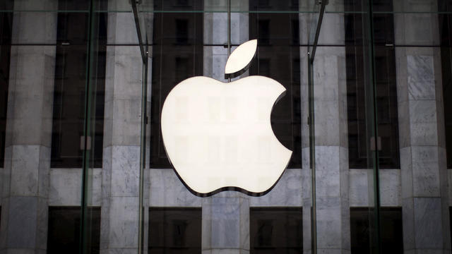 An Apple logo hangs above the entrance to the Apple store on Fifth Avenue in the Manhattan borough of New York City July 21, 2015. 