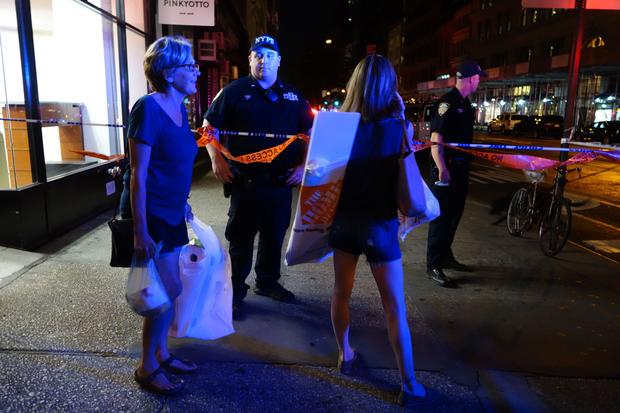 Two women look on as police block a road after an explosion in New York on Sept. 17, 2016. An explosion in New York’s Chelsea neighborhood injured multiple people, police said. 