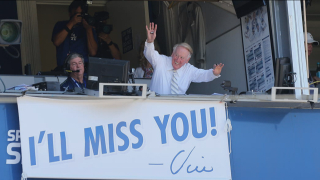 Los Angeles Dodgers broadcaster Vin Scully waves to the crowd during a game against the Colorado Rockies at Dodger Stadium in Los Angeles Sept. 25, 2016. 