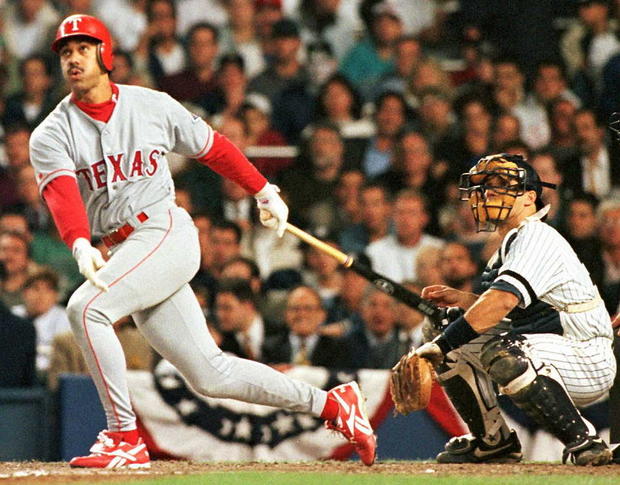 Texas Rangers' Juan Gonzalez watches his three-run 