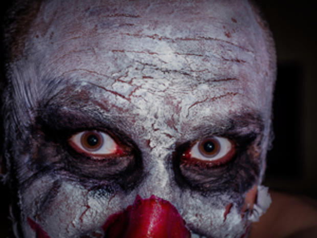 scary clown face isolated on black background colour image, horror 