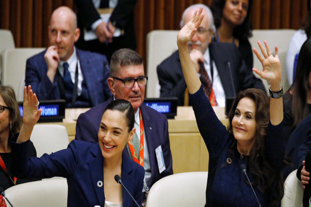 Actors Gal Gadot and Lynda Carter wave during an event to name Wonder Woman the U.N. honorary ambassador for the empowerment of women and girls at the United Nations headquarters in the Manhattan borough of New York Oct. 21, 2016. 