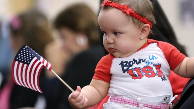 Cuban immigrant Ed Lacosta, unseen, holds his baby, Melody Grace, 6 months, while sitting with his wife, Judy Lacosta, at a special Valentine&rsquo;s Day naturalization ceremony for married couples on Feb. 14, 2013, in Tampa, Florida. 