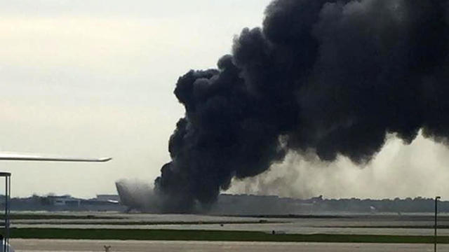 Smoke rises from a fire on a passenger plane at Chicago O’Hare International Airport on Oct. 28, 2016. 