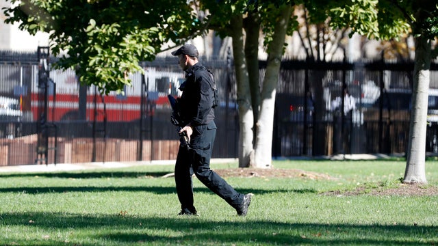 A U.S. Secret Service officer walks the grounds near the North Portico during a lockdown at the White House Nov. 5, 2016, in Washington. 