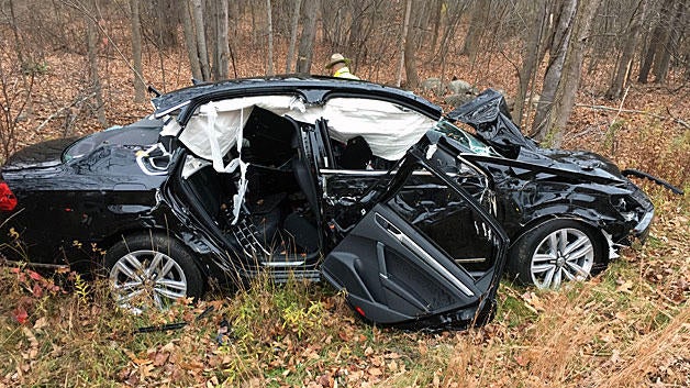 Crews work the scene after a woman was rescued from an overturned car in Epping, New Hampshire, on Nov. 15, 2016, in this photo provided to CBS Boston station WBZ-TV. 