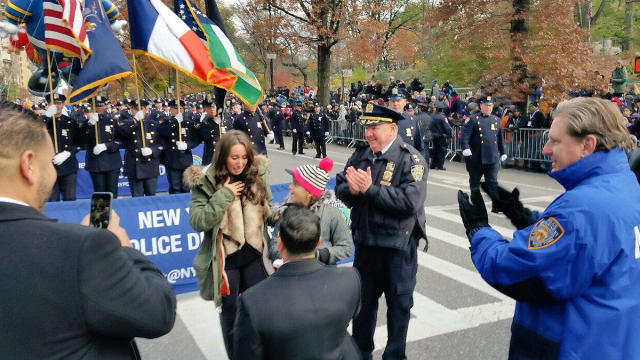 New York police Officer Andrew Dossi proposes to his girlfriend during the Thanksgiving Day Parade in New York Nov. 24, 2016. 