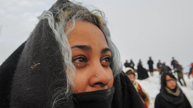 A woman cries during the sunrise in Oceti Sakowin camp as protesters continue to demonstrate against plans to pass the Dakota Access pipeline near the Standing Rock Indian Reservation, near Cannon Ball, North Dakota, on Dec. 3, 2016. 