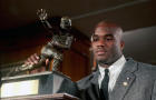 Colorado’s Rashaan Salaam poses with his 1994 Heisman Trophy at the Downtown Athletic Club in New York on Dec. 10, 1994. 