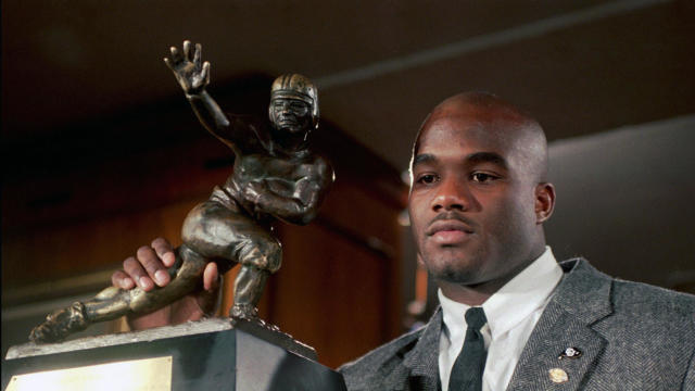 Colorado’s Rashaan Salaam poses with his 1994 Heisman Trophy at the Downtown Athletic Club in New York on Dec. 10, 1994. 