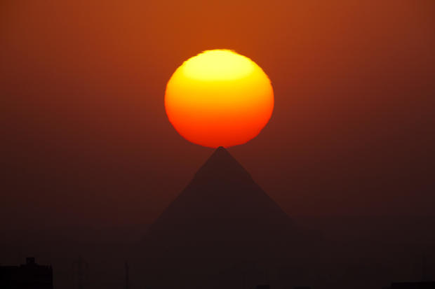 The sun sets over the Giza pyramids, near Cairo, Egypt, Aug. 19, 2016. 