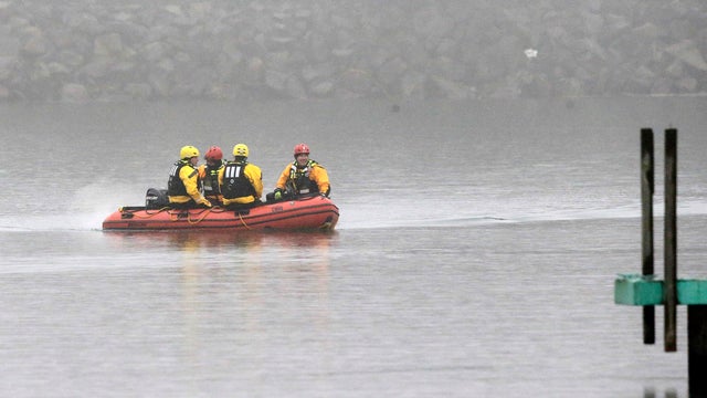 A boat carrying a recovery team rides on the shoreline of Lake Erie Jan. 3, 2017, in Cleveland. 