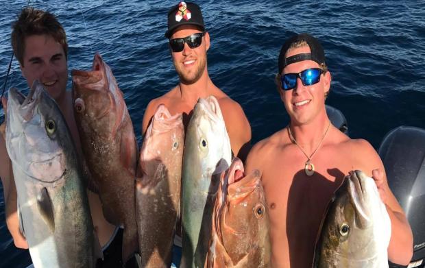 Taylor Danowski, center, and two of his friends hold up their amberjack and grouper before stumbling upon the real highlight of their fishing trip Jan. 16, 2017. 
