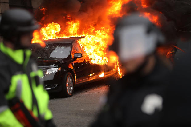 Police and demonstrators clash in downtown Washington after a limo was set on fire following the inauguration of President Trump on Jan. 20, 2017, in Washington. 