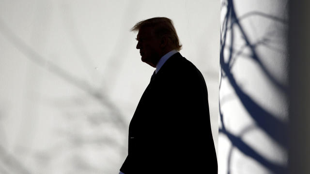 President Trump walks through the Colonnade to the Oval Office after returning to the White House in Washington Jan. 26, 2017. 