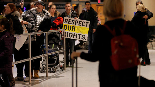 Demonstrators protesting President Trump’s travel ban executive order greet arriving passengers at Logan Airport in Boston Jan. 28, 2017. 