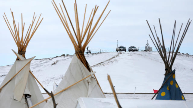 Police vehicles idle on the outskirts of the opposition camp against the Dakota Access oil pipeline near Cannon Ball, North Dakota, Feb. 8, 2017. 