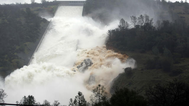 Water flows through a break in the wall of the Oroville Dam spillway Feb. 9, 2017, in Oroville, Calif. 