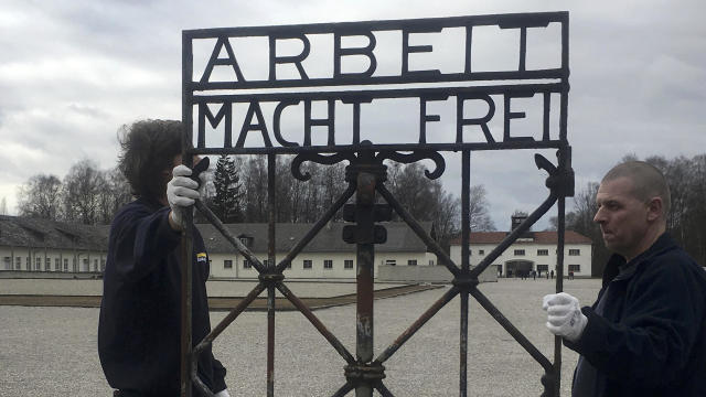 Workers hold an iron gate from Dachau concentration camp with the notorious “Arbeit macht frei” (“Work sets you free”), which was returned to Dachau, Germany, Feb. 22, 2017, after it was stolen in 2014. 