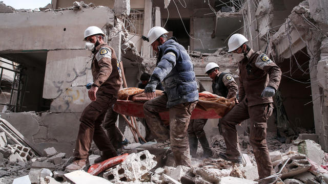 Syrian civil defense volunteers, known as the White Helmets, search for survivors following a reported government airstrike on the rebel-held neighborhood of Tishrin, on the northeastern outskirts of the capital Damascus, on Feb. 22, 2017. 