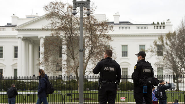 Members of the Secret Service Uniformed Division patrol alongside the security fence around the perimeter of the White House in Washington March 18, 2017. 