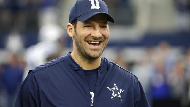 Dallas Cowboys quarterback Tony Romo smiles as he talks with teammates on the field during warmups before an NFL football game against the Cincinnati Bengals on Sun., Oct. 9, 2016, in Arlington, Texas. 