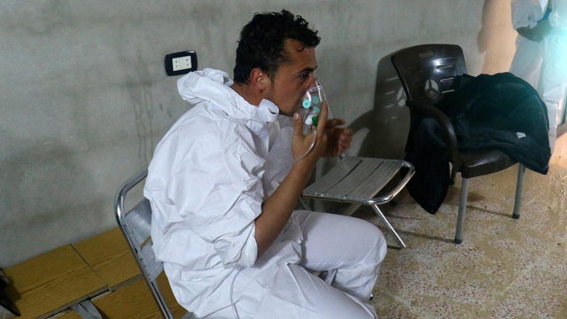 A man breathes through an oxygen mask after what rescue workers described as a suspected gas attack in the town of Khan Sheikhoun in rebel-held Idlib, Syria, April 4, 2017. 