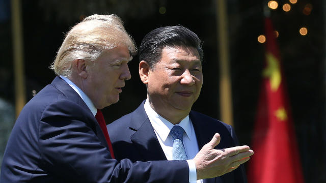 President Trump and China’s President Xi Jinping chat as they walk along the front patio of the Mar-a-Lago estate after a bilateral meeting in Palm Beach, Florida, April 7, 2017. 