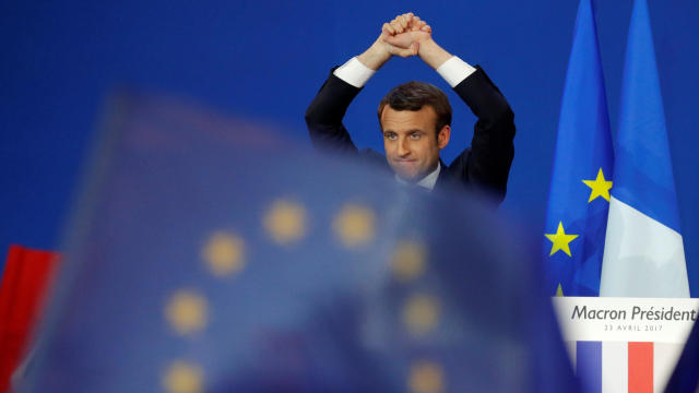 Emmanuel Macron, head of the political movement En Marche, or Onwards, and candidate in the French presidential election, celebrates on stage at the Parc des Expositions hall in Paris after partial results in the election's first round April 23, 2017. 