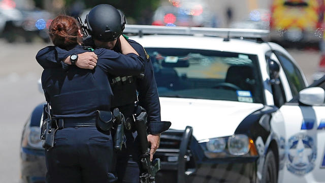 Dallas police officers embrace after police responded to a shooting incident in Dallas, Texas, May 1, 2017. 