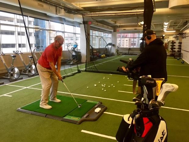 Patient in Rochester getting his swing analyzed 