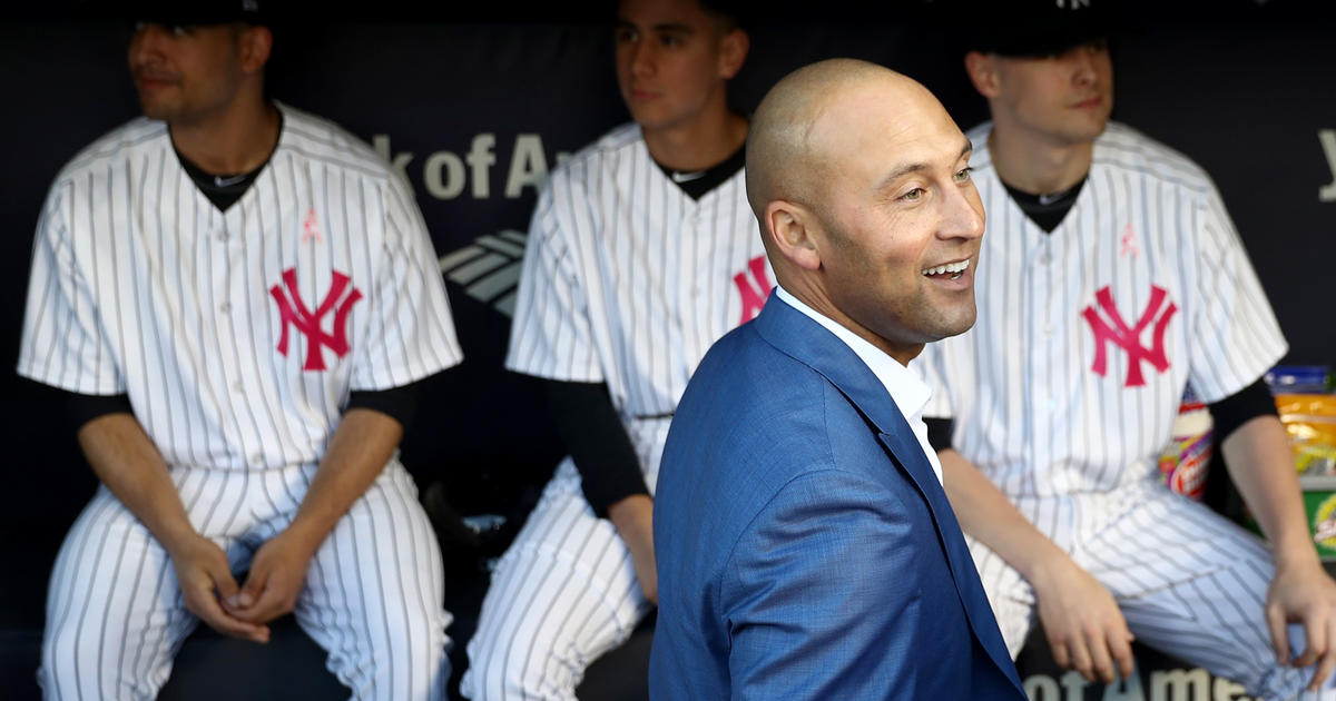 Bernie Williams and his family stand next to his retired number in News  Photo - Getty Images