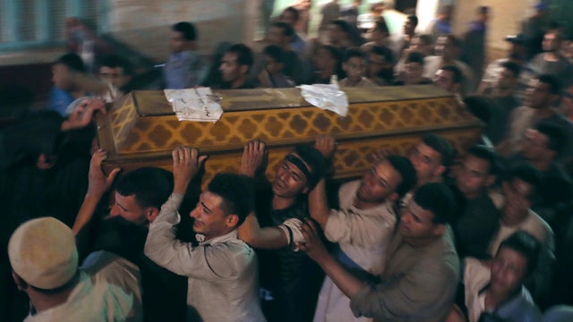 Mourners carry a coffin at the funeral of Coptic Christians who were killed in Minya, Egypt, May 26, 2017. 