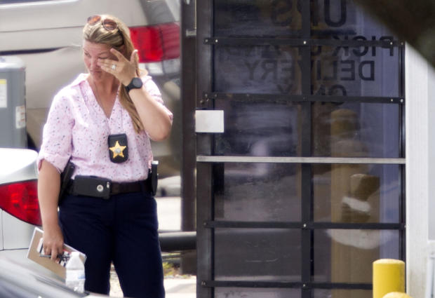 A law enforcement official wipes her eyes at the entrance to a shooting crime scene in Orlando, Florida, on June 5, 2017. 