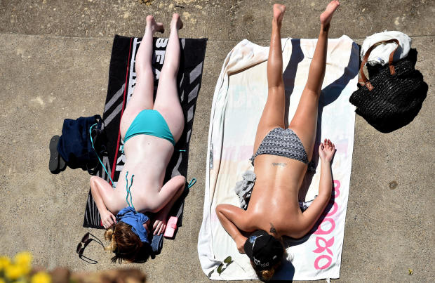 Women sunbathe at Bondi Beach in Sydney on Feb. 23, 2016. 