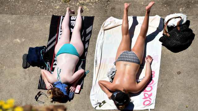 Women sunbathe at Bondi Beach in Sydney on Feb. 23, 2016. 