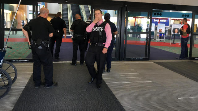 Police officers gather at a terminal at Bishop International Airport June 21, 2017, in Flint, Michigan, after an airport police officer was stabbed. 