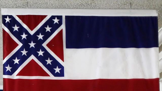 The state flag of Mississippi, which incorporates the flag of the Confederate States of America in the top left corner, is displayed with the flags of the other 49 states and territories in a tunnel connecting a Senate office building and the U.S. Capitol 