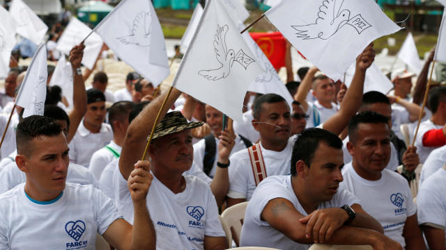 FARC rebels wave flags of peace during the final act of abandonment of arms in Mesetas, Colombia, June 27, 2017. 