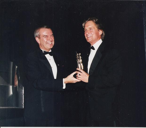 Michael Douglas stands with Michael Kutza and his Career Achievment Award at the 33rd Festival in 1997 