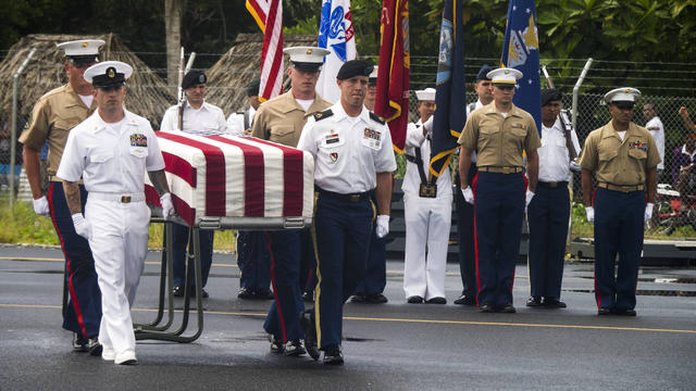 Members of the Defense POW/MIA Accounting Agency carry a transfer case during a repatriation ceremony for service members missing in action from the battle of Tarawa, Republic of Kiribati, July 25, 2017. 